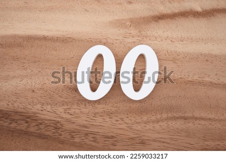 White number 00 on a brown and light brown wooden background.