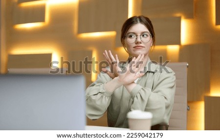 Stop gesture, businesswoman disagree, denial. Woman in office workplace says no. Royalty-Free Stock Photo #2259042179