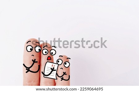 Two fingers are decorated as two person. They are not happy for the poor performance. Royalty-Free Stock Photo #2259064695