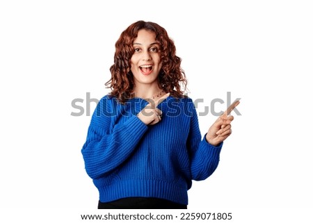 Cute millennial woman wearing pullover sweater standing isolated over white background smiling and looking at the camera pointing with two hands and fingers to the side.