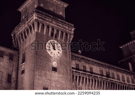 A stunning image of the historic Castle of Ferrara illuminated at night, showcasing its beautiful details and architecture.