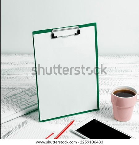Notebook With Important Messages On Desk With Coffee, Phone And Pen. Crutial Informations Written On Pad On Table With Cup, Memos And Pencil. Late Updates Presented.