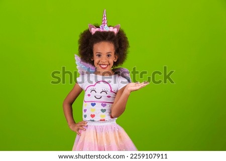 Cute little girl in unicorn costume happy on children's day Royalty-Free Stock Photo #2259107911