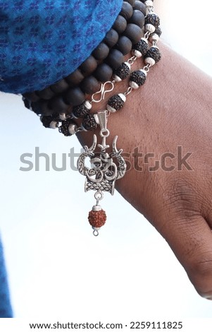 picture of hand wearing spiritual symbols of Hindu religion 