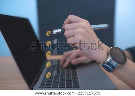 Asian male businessman pressing a button to assess satisfaction