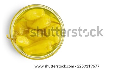 Pickled yellow pepper, pepperoncini or friggitelli in bowl isolated on white background. Hot pepper marinated, brined. Traditional Italian and greek cuisine, ingredient for salad, pasta, sauce. Royalty-Free Stock Photo #2259119677