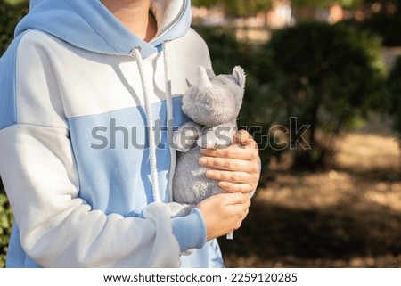 Girl holding a toy,
hippo toy