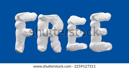 Free word lettering made of shaving foam letters on blue background, writing with white foam
