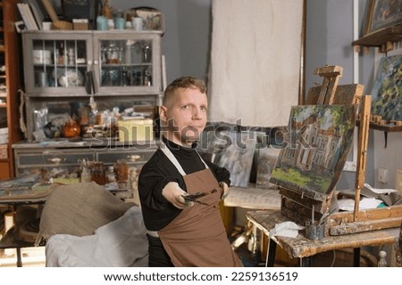 a man with disabilities draws pictures and is engaged in art.
