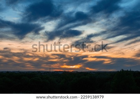 Dramatic late evening sunset over the city Royalty-Free Stock Photo #2259138979