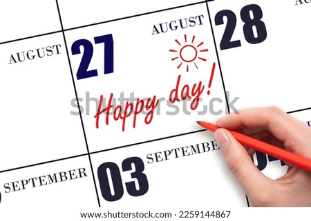 27th day of August. Hand writing the text HAPPY DAY and drawing the sun on the calendar date August 27. Save the date. Holiday. Motivation. Summer month, day of the year concept.