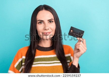 Portrait photo of serious confident satisfied lady wear orange shirt hold plastic new premium fast remote pay atm isolated on cyan color background