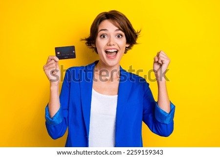 Photo of astonished business lady hold credit card raise fist up successful shopping bonus isolated bright color background