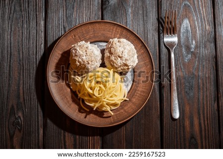 Spaghetti on a plate with two large meatballs. Background picture.