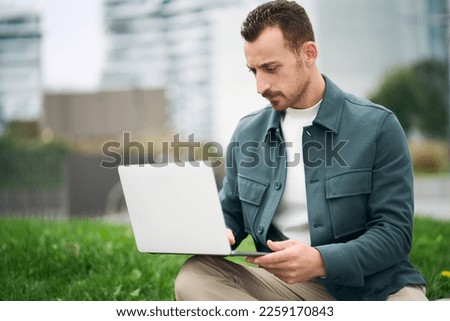 University student studying online using laptop while sitting in campus alone. Online education concept. Stock photo