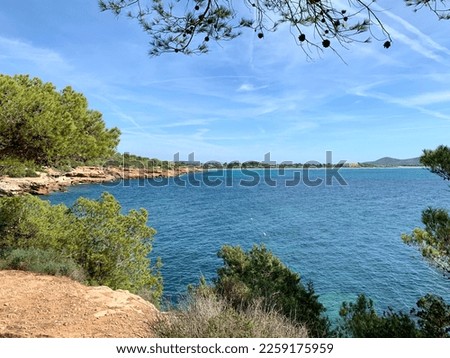 Picture of a large body of water, surrounded by trees and mountains
