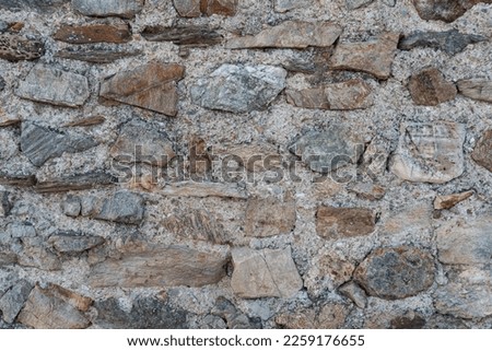 A wall of rocks. A wall made of stones. Rock background.