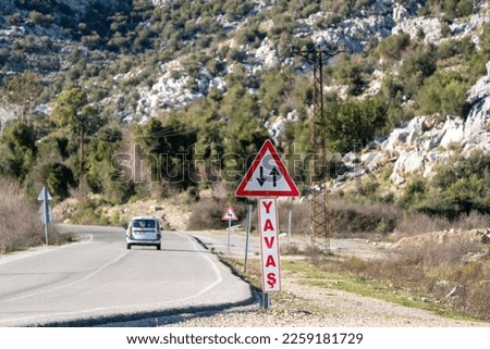 Slow on curve warning and two-way traffic sign.
Translation,ENGLİSH -SLOW = TURKISH -YAVAŞ