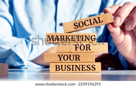 Close up on businessman holding a wooden block with "Social Marketing for Your Business" message
