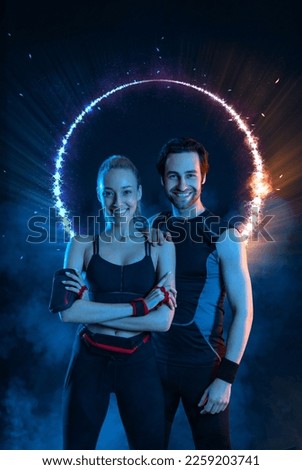 Download photo for advertising a fitness club in social networks. Fitness Influencers. Fitness couple at home. Cover for sport motivation music. Fit man and woman at the gym on black background.