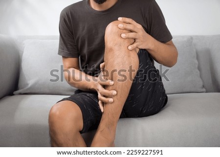 Man having leg muscle pain Royalty-Free Stock Photo #2259227591