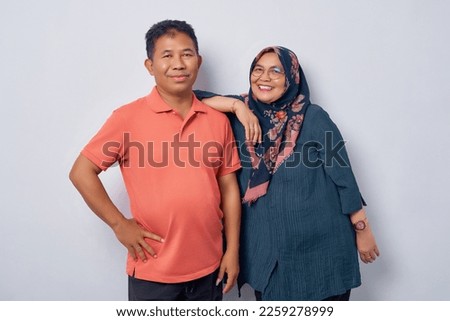 Smiling couple Asian woman man 50s standing hugging and looking camera with smiling facial expression and happy isolated on white background studio portrait