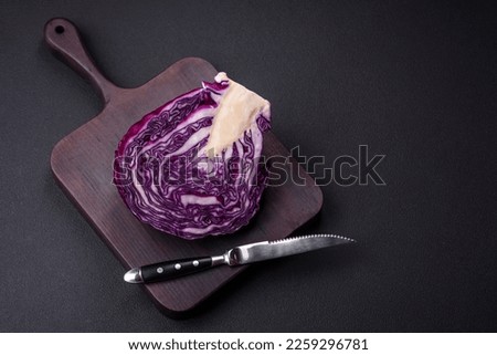 Fresh beautiful red cabbage with textured leaves on a dark concrete background. Vegetarian cooking