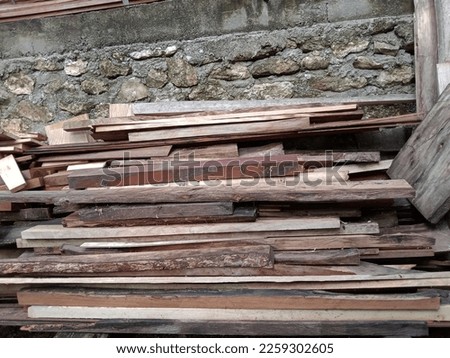 Pile of new and old wood pieces in yard, Wood construction material.