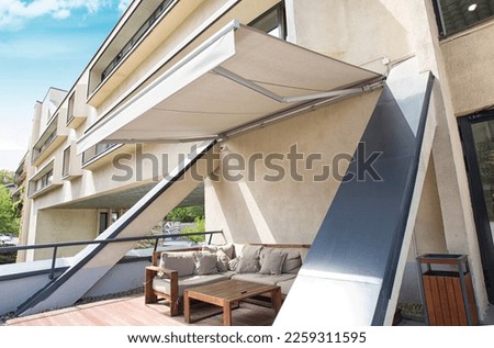 comportable teracce with awning and sofa Royalty-Free Stock Photo #2259311595