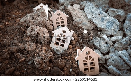 Small wooden houses on the ground and stones,earthquake concept 2023. Copy space  Royalty-Free Stock Photo #2259314683