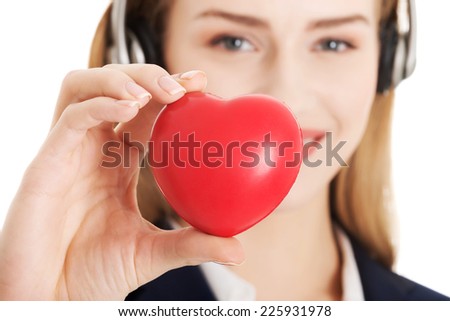 Young call center woman holding heart