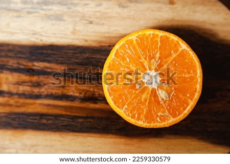 Flat lay of a few pieces of orange fruit on a wooden table