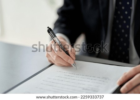 Asian businessman signing a contract Royalty-Free Stock Photo #2259333737