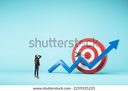 Perspective back view on pensive woman looking at red and white target with bullseye dart and blue growing up arrow on blank light background with place for advertising poster or logo brand, mock up Royalty-Free Stock Photo #2259335225