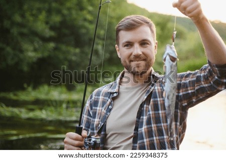 Fisherman hunting trouts in mountain river. Fishing net detail