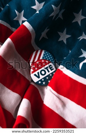 Political vote, election pin on American flag. Black background. Democrat vs republican poll. Royalty-Free Stock Photo #2259353521