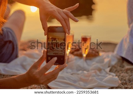 woman takes pictures of breakfast and chooses the best angle and composition on smartphone. food and travel blogger in work. closeup view