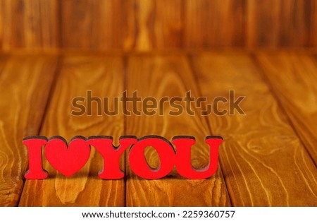 wooden inscription I love you on a wooden background close-up