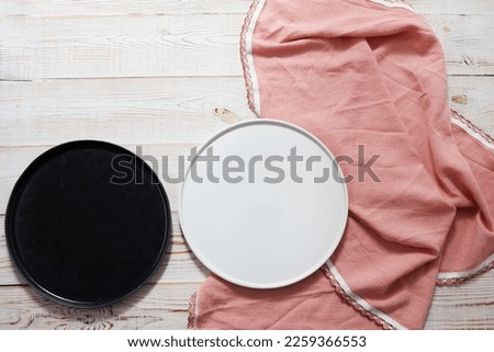 two empty ceramic food trays and a tablecloth on the table top view