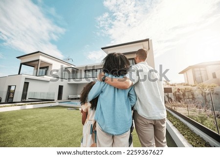 Love, new home and family standing in their backyard looking at their property or luxury real estate. Embrace, mortgage and parents with their children on grass at their house or mansion in Canada. Royalty-Free Stock Photo #2259367627