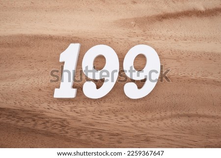 White number 199 on a brown and light brown wooden background.