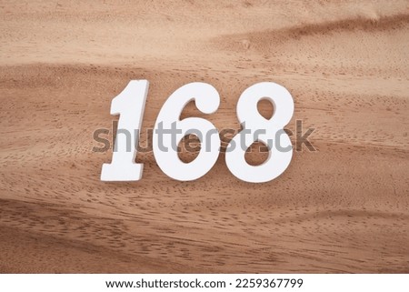 White number 168 on a brown and light brown wooden background.