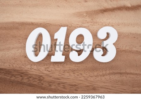 White number 0193 on a brown and light brown wooden background.