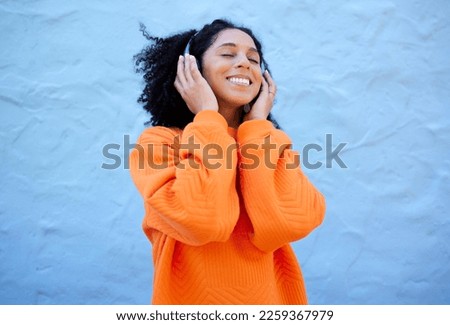 Happiness, black woman and headphones for streaming, music and cheerful on blue studio background. African American female, lady or headset for audio, sounds and podcast with girl, smile and backdrop