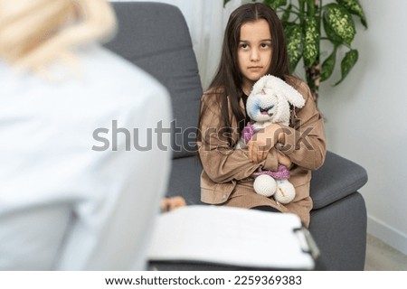Young female psychologist talk with girl teenager. Caring woman social worker have meeting with teen schoolgirl Royalty-Free Stock Photo #2259369383