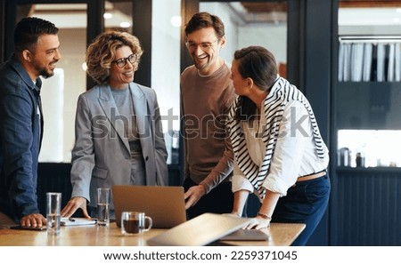 Group of business people having a meeting in a tech company. Creative business professionals planning a project in an office. Teamwork and collaboration in a modern workplace. Royalty-Free Stock Photo #2259371045