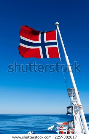 Norwegian flag on a ship's mast, waving in the wind