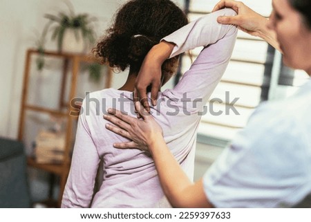 Teen Girl having chiropractic back adjustment. Osteopathy, Physiotherapy, Kinesiology. Bad posture correction Royalty-Free Stock Photo #2259397633