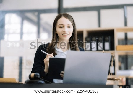 Female lawyer working at table at home office in the morning.