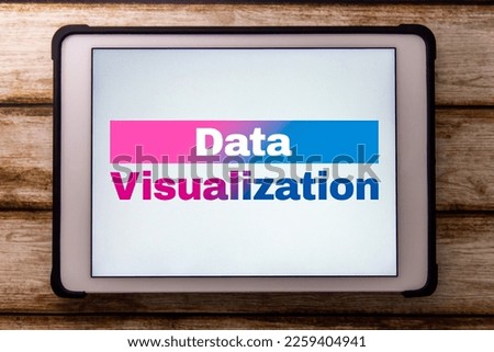 Conceptual keyword “Data Visualization” on tablet on faded shabby table. Visualize the data for business purpose concept.